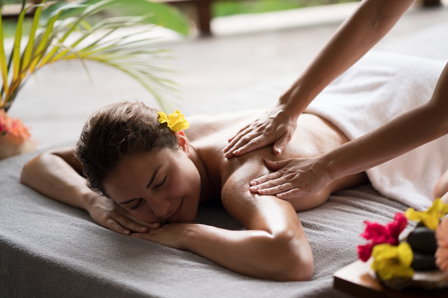 Smiling woman enjoying in a back massage at the spa.